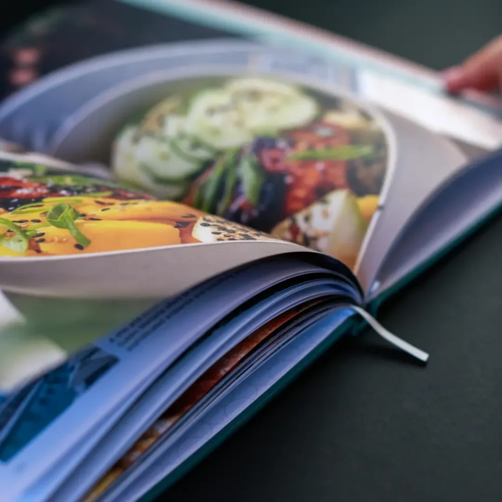 Open premium printed book featuring full colour food photography and high quality page reproduction.