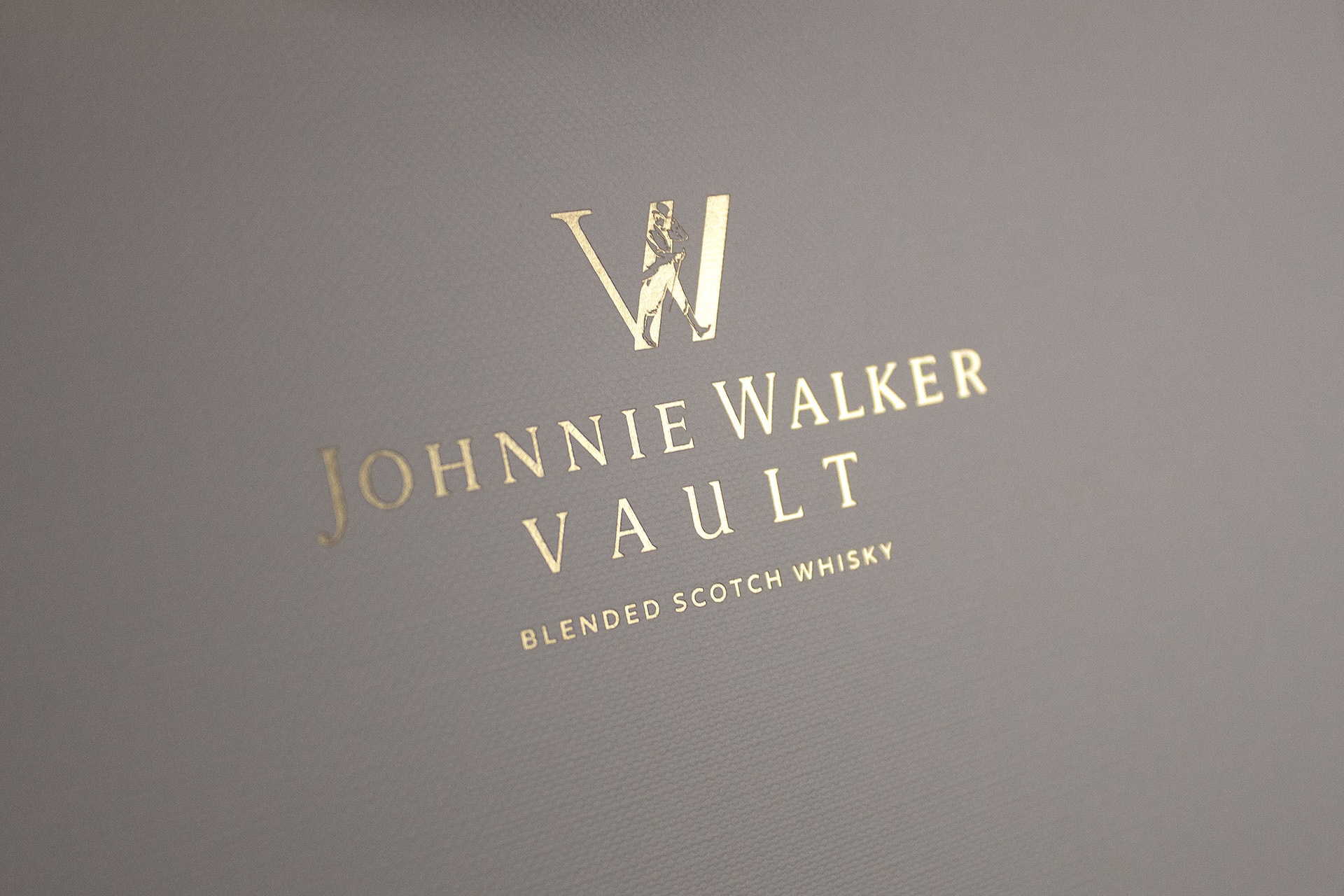 Johnnie Walker Vault Luxury paper carrier bags manufactured using Colorplan Bright White Embossed stock with gold foil branding and ribbon handles